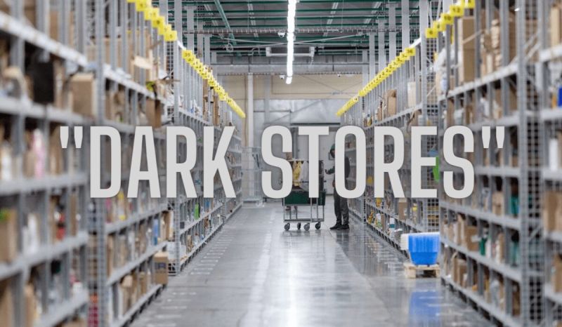 Aisle of a dark store warehouse with shelves of grocery orders